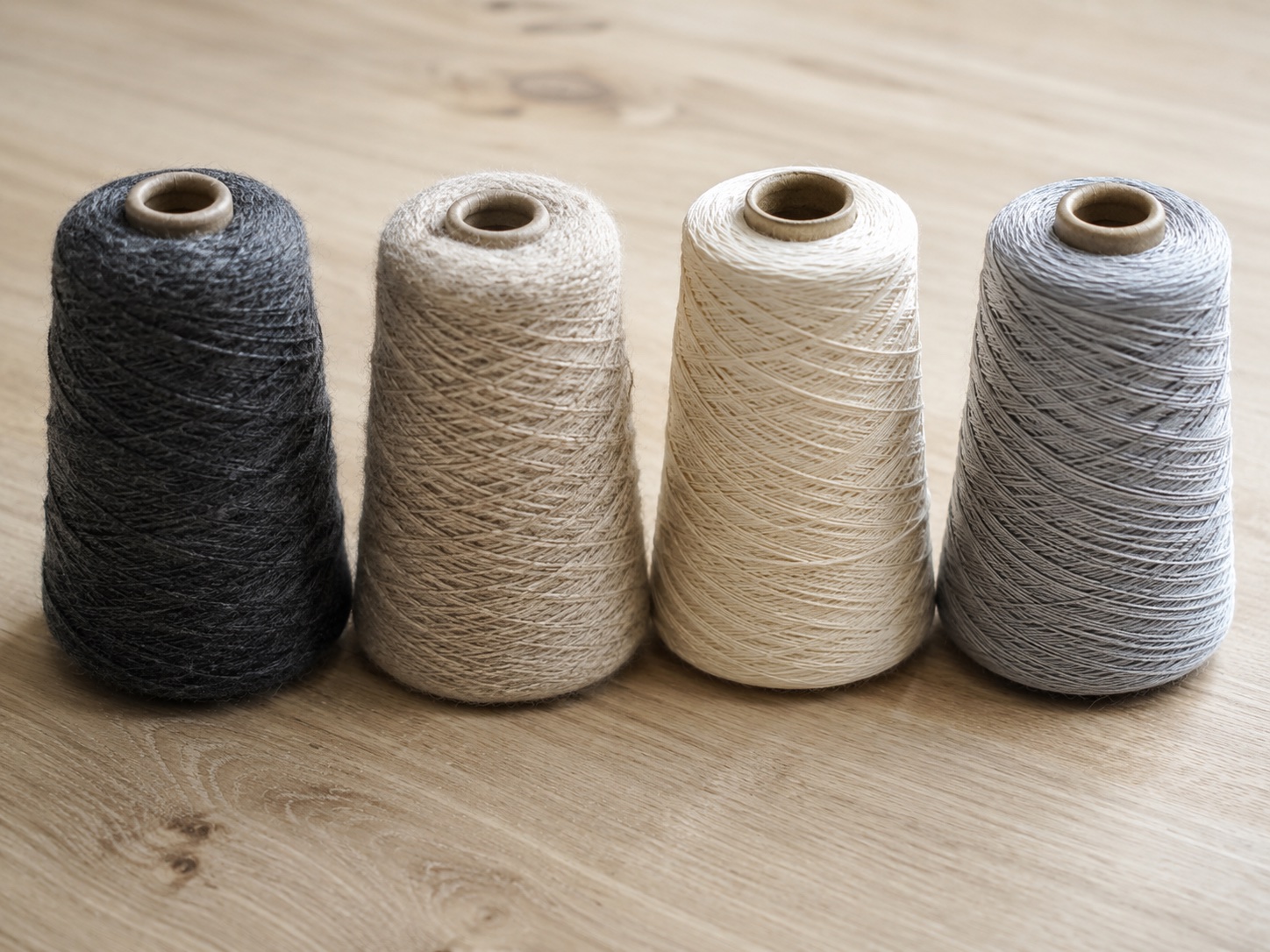 Four cones of yarn in merino, lambswool, cotton and bamboo viscose